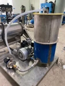 Apparecchiatura industriale per impianti di rigenerazione montata su una base metallica in un laboratorio di ricerca.