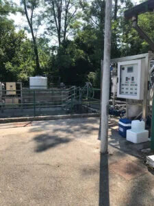 Impianto esterno per il trattamento di acque reflue industriali con pannello di controllo e serbatoi di stoccaggio.